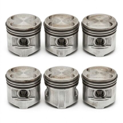 Close-up view of metal engine pistons with piston rings used in automotive engine assembly