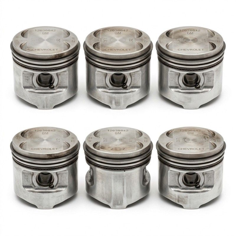 Close-up view of metal engine pistons with piston rings used in automotive engine assembly